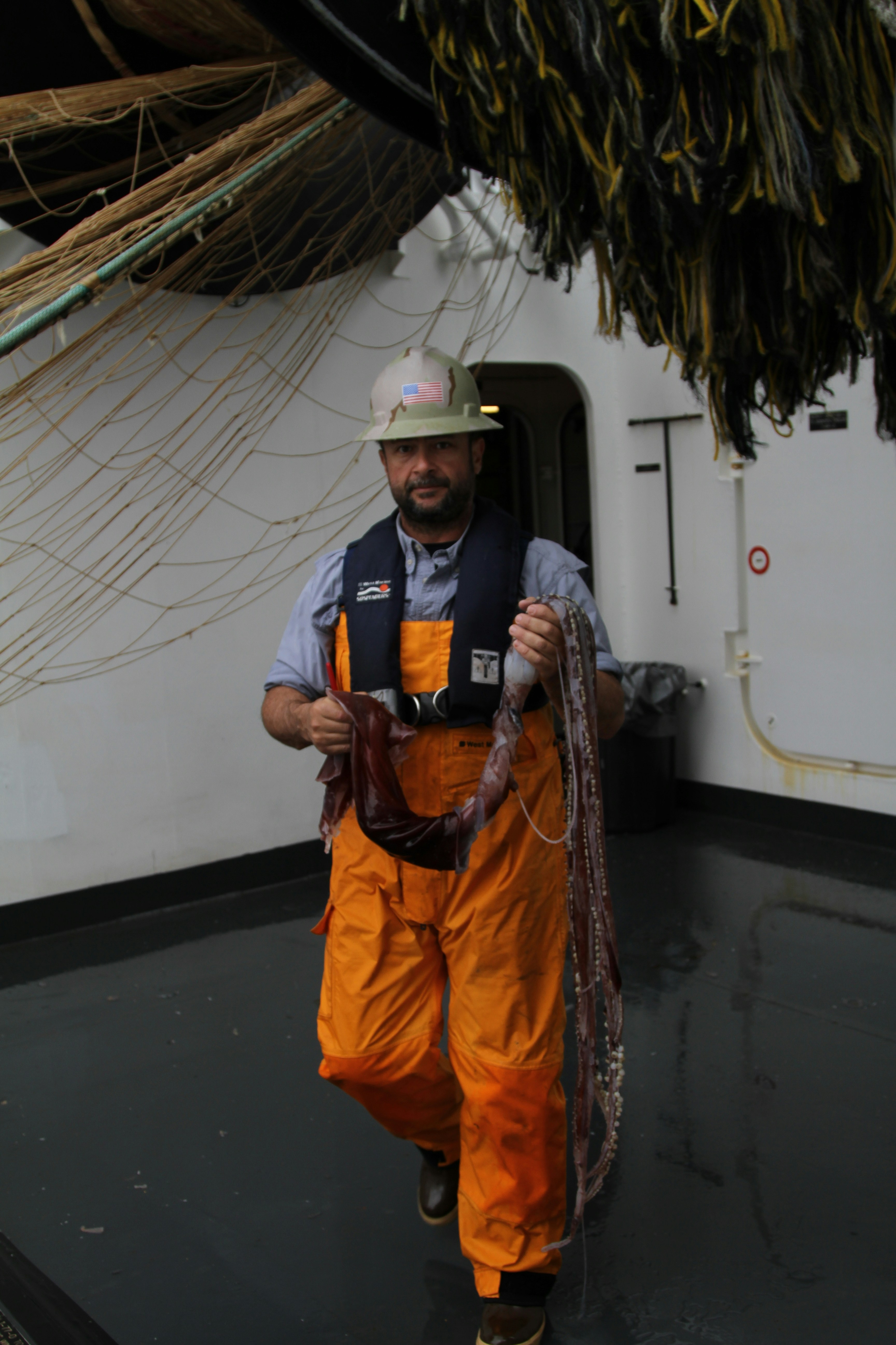 Marine engineer carrying rope